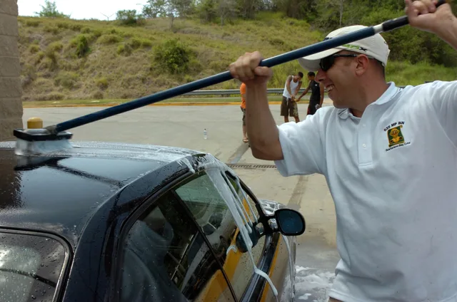 Army Staff Sgt. Joseph Lobban foam-scrubs a patron's car clean at the Joint Task Forces' Joint Detention Group Ball Carwash fundraiser, May 24, at the car washing station near the Lyceum Theater. The car wash was held as a fundraiser for the JDG Ball in September to help offset the cost for the atte. 3 pointers on car wash pricing that hold up