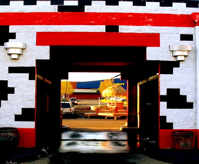 A view of a Best Buy through the bay of a car wash. Looking northwards through the second car wash bay on the left at Classique Auto Detail and Carwash, 9550 Ridgetop Blvd NW, Silverdale , Washington state, United States. Colorful Car Wash. Car wash daily SOPs, explained item by item