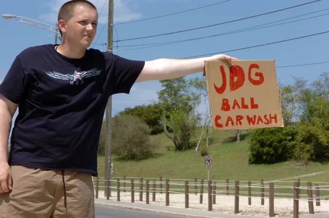 Army Pfc. Carl Grimm holds out a sign, attempting to pull in drivers for the Joint Task Forces' Joint Detention Group Ball Carwash fundraiser, May 24, at the car washing station near the Lyceum Theater. The car wash was held as a fundraiser for the JDG Ball in September to help offset the cost for t. Does the International Carwash Association set real US bay standards?